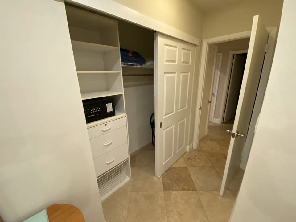 Master bedroom .Closet with extra pillow, bed sheets and beach towels