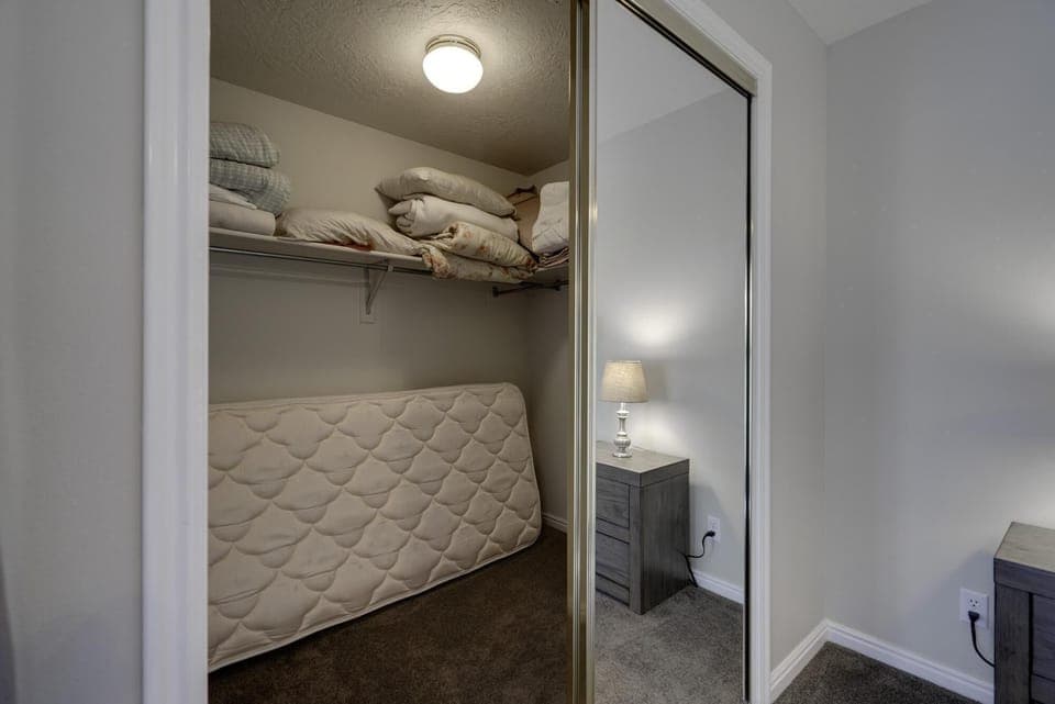 Master bedroom walk-in closet.  Twin mattress for extra sleeping.
