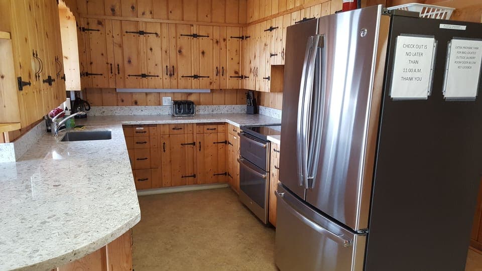 Kitchen with new quartz counter tops and stainless steel appliances