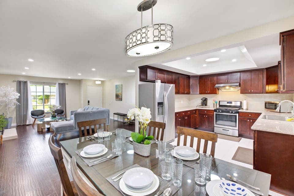 Open concept house with large kitchen with newer appliances and dining set