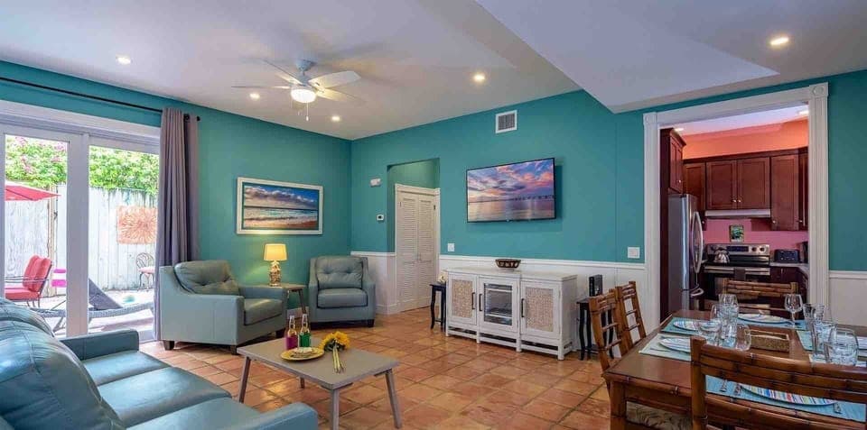 The open living room features a large flat screen TV and comfortable seating...