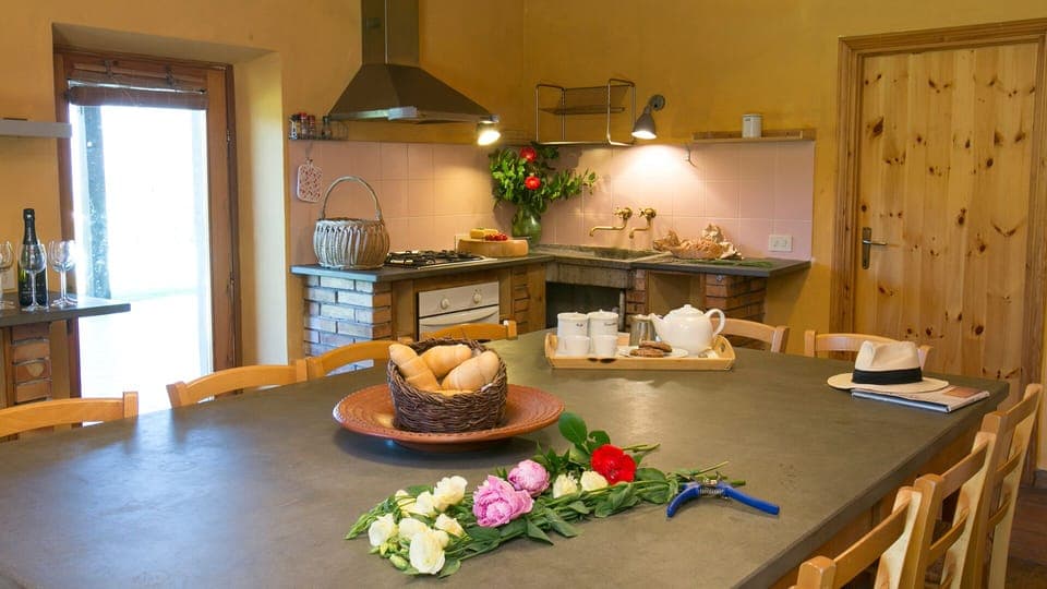 Large kitchen with dining table and access to outdoor eating area