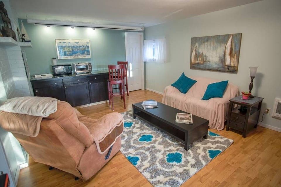Living room w/ fridge, coffee pot (coffee provided), microwave and toaster oven
