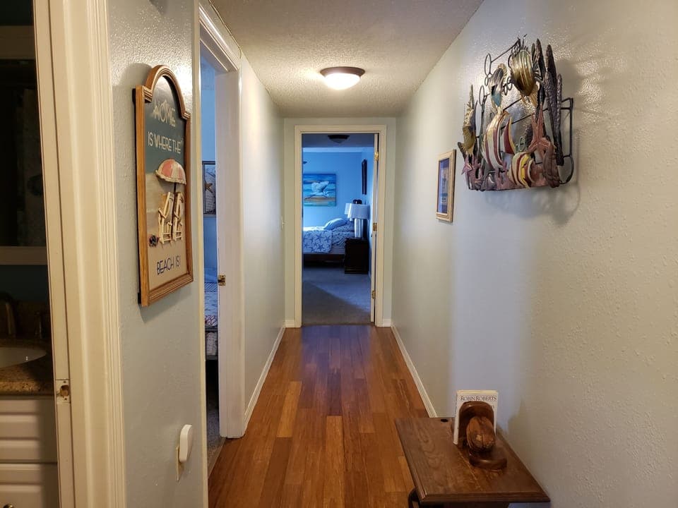 This hall separates the living areas and the bedrooms/bathrooms