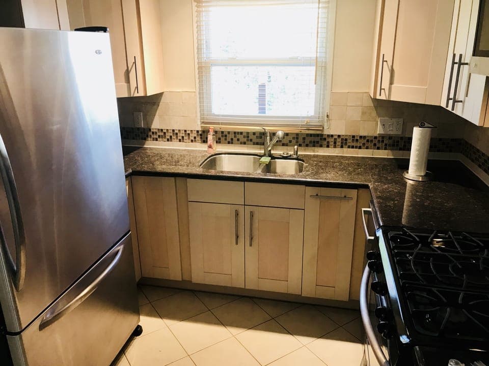 Full sized fridge and granite counters