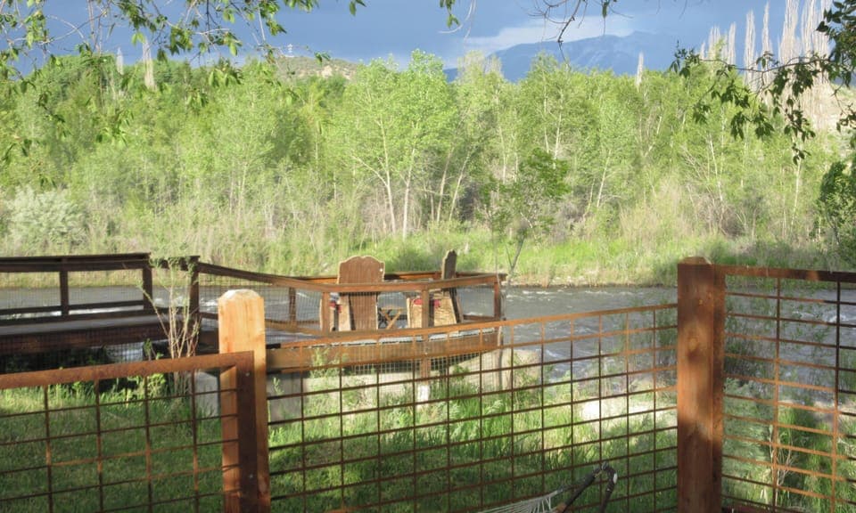 Fenced in dog yard that can also be the field of relief in a pinch for doggie do