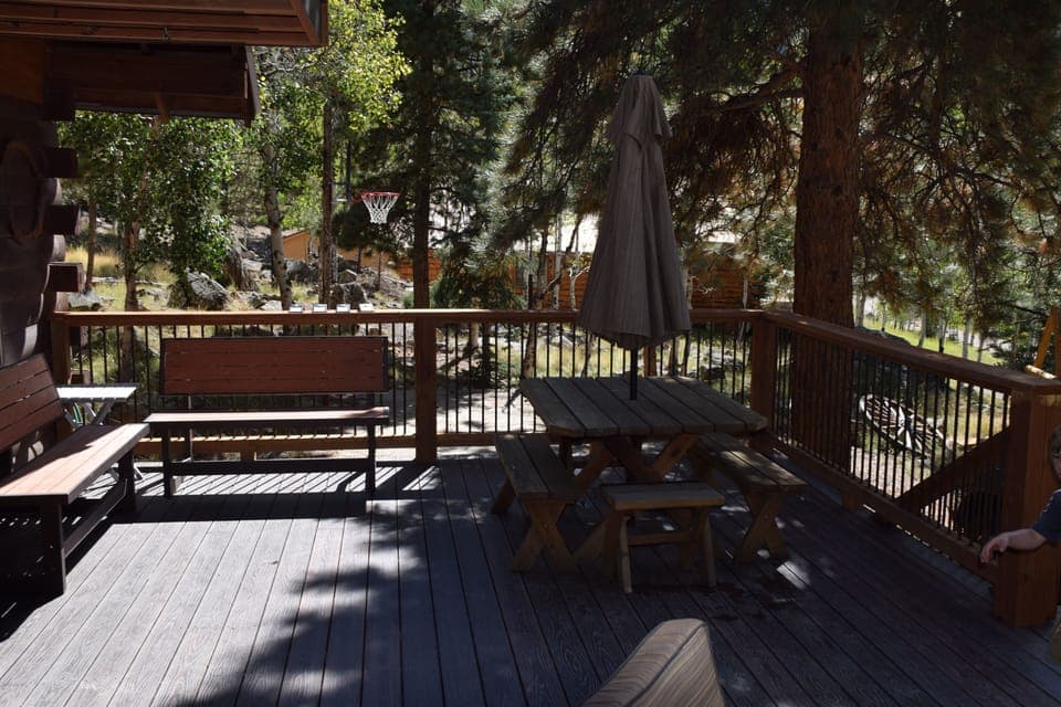 1/2 of main deck. Basketball court in background. Benches convert to tables