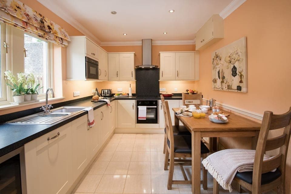 Dryburgh Stirling One - kitchen with plenty of storage and table seating four guests