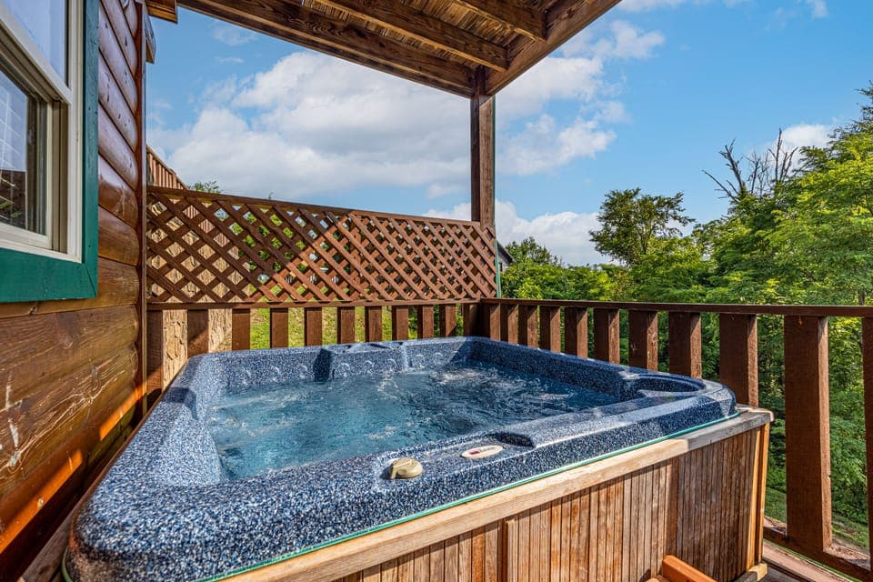 Enjoy a private hot tub on the deck, offering relaxation with scenic views.