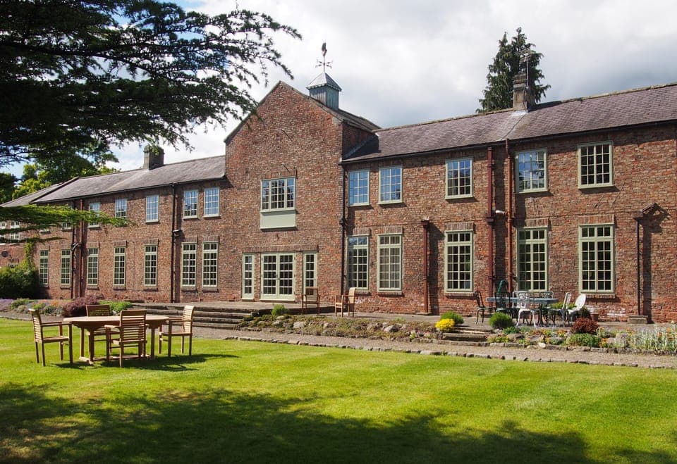 The Southside of the house as viewed from the tennis court.