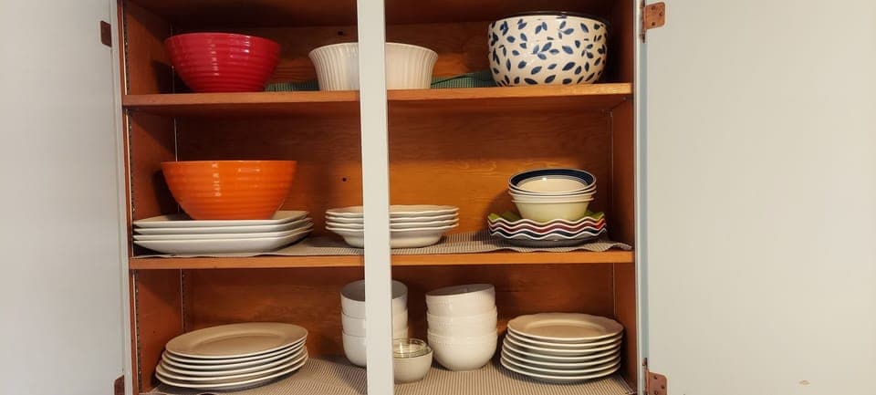 Glasses, mixing bowls, coffee mugs, paper filter coffee maker. 