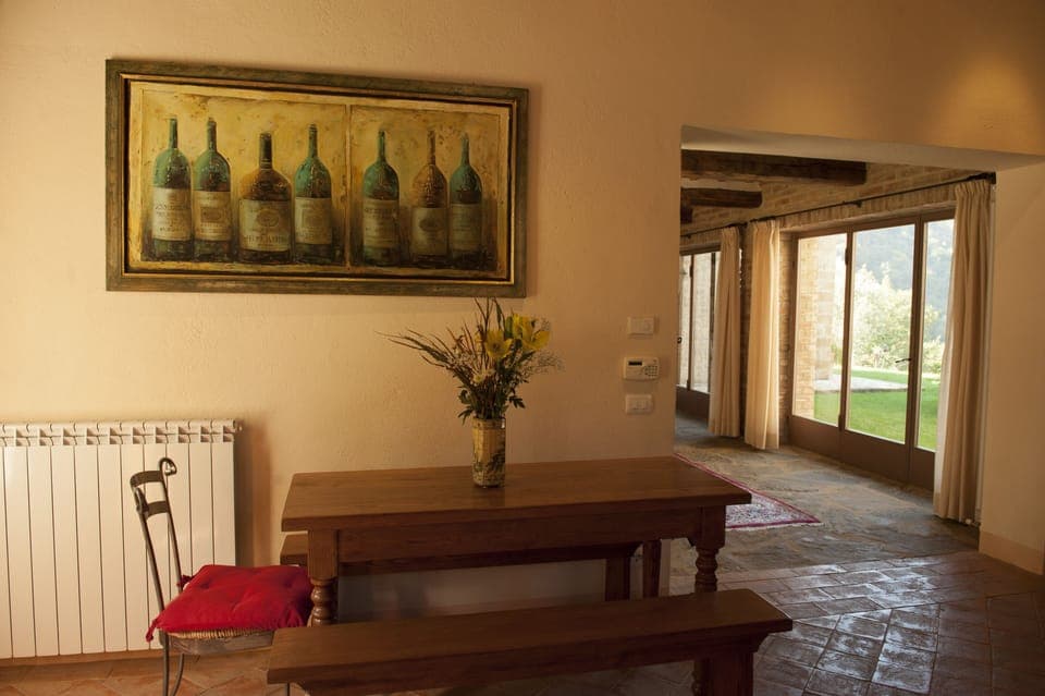 Kitchen breakfast table with local artwork. Leads to Living Room. 