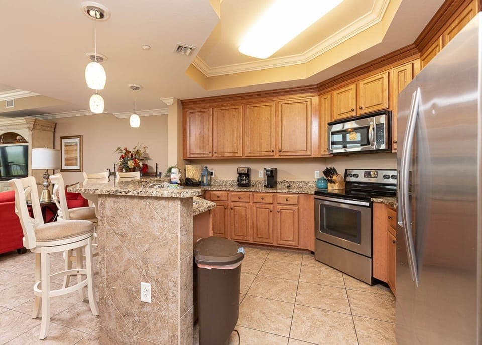 This kitchen features granite countertops, stainless appliances, and a cozy breakfast bar, perfect for morning coffee