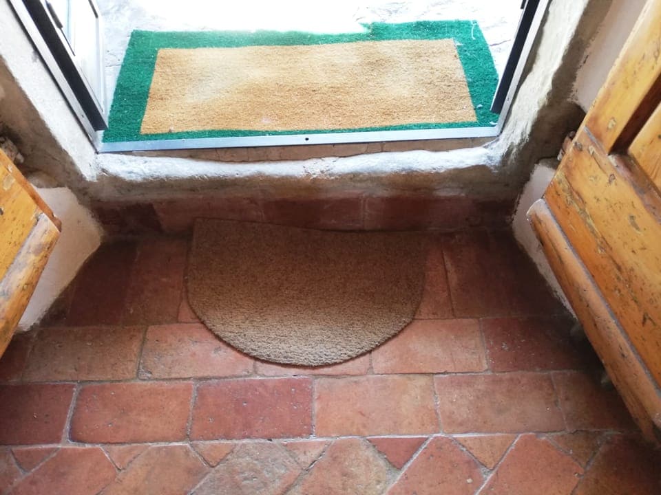 One step down from Portico into Villa MURGIANO's  Summer Kitchen & Lounging area