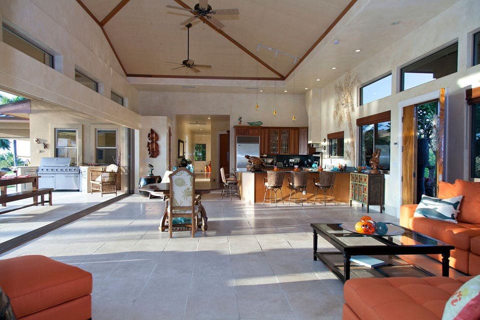 High ceilings in living room with oversized pocket doors to covered lanai.