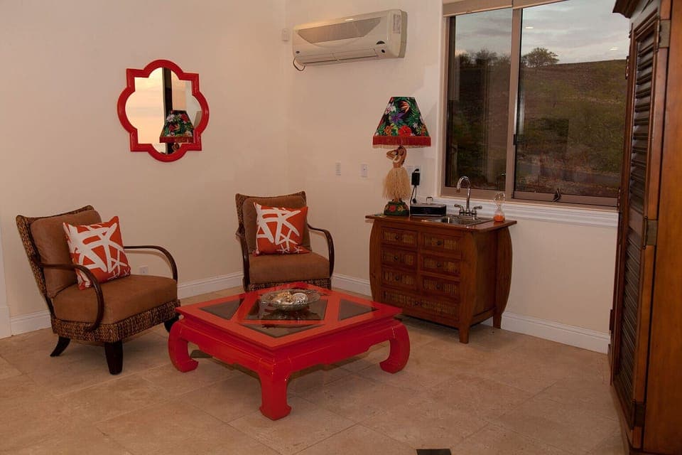 Sitting area of guest quarters with flat screen TV, extra sink. Lots of privacy