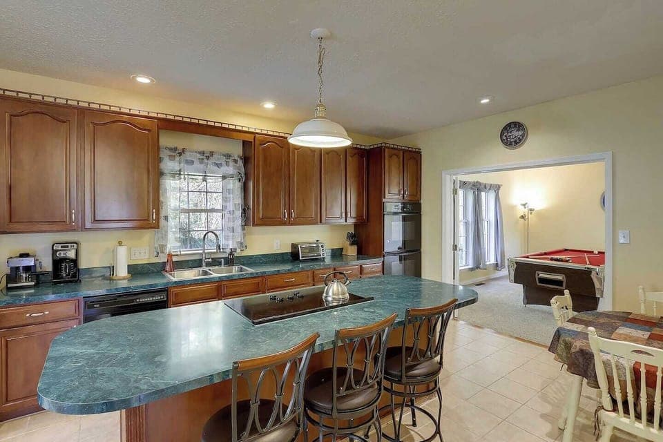 Large eat in kitchen is fully stocked with supplies.