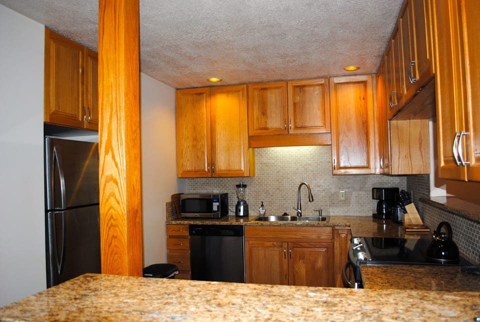 Fully stocked kitchen with new stainless steel appliances and granite counters