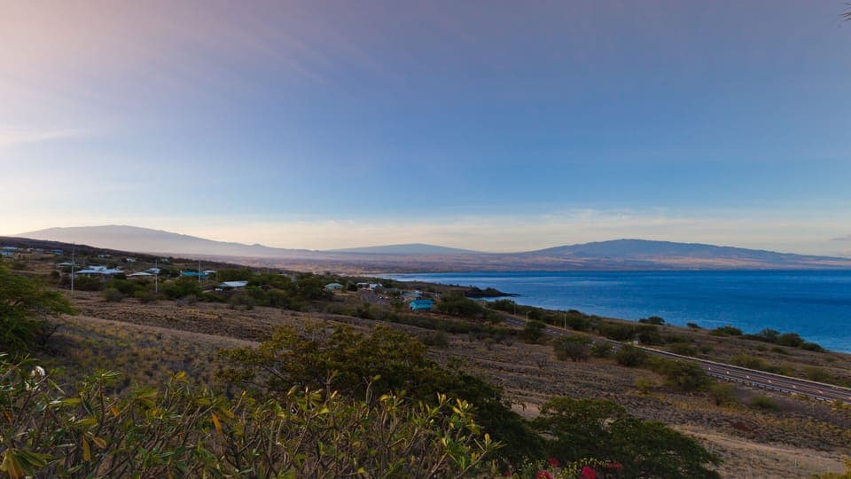Ali'i Master views of sunrise shining over volcanic mountains & Kohala coastline