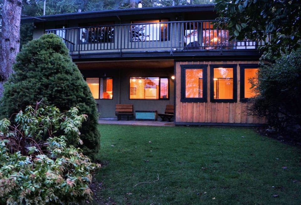 photo of the suite lit up at night, you can see the big trees in the background