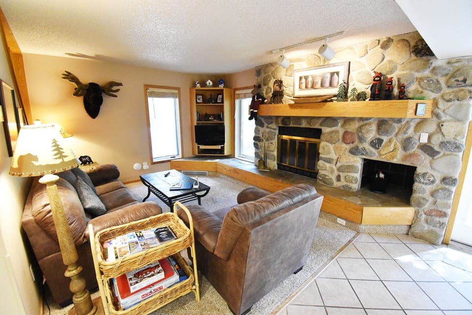 Living Room with River Rock Fireplace - Living Room with River Rock Fireplace