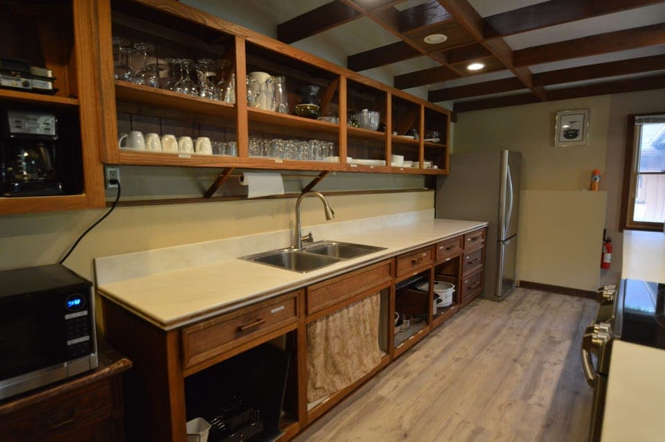 Large galley kitchen with fully equipped utensils, pots and pans.