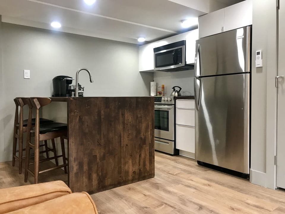 Well-equipped kitchen with ice maker, Keurig, grinder, and French press.