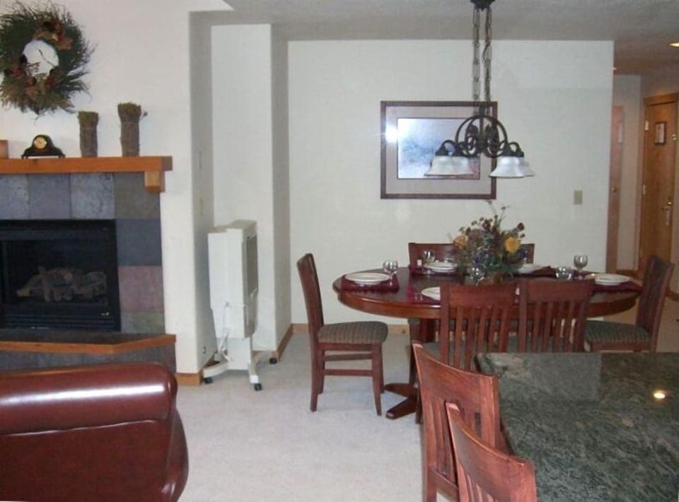 Large open kitchen, dining room, living room, deck, and gas fireplace.