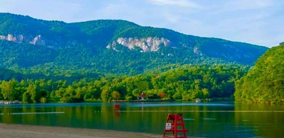 Summer time at Lake Lure Beach with childrens play area and lifeguards in summer
