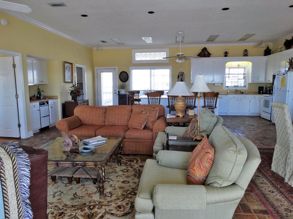 Entering the house to the left is the living room and beyond is a large kitchen.