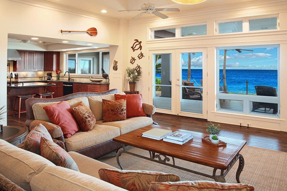 LIVING ROOM OCEAN VIEWS. FULLY EQUIPPED KITCHEN IN BKGRND.