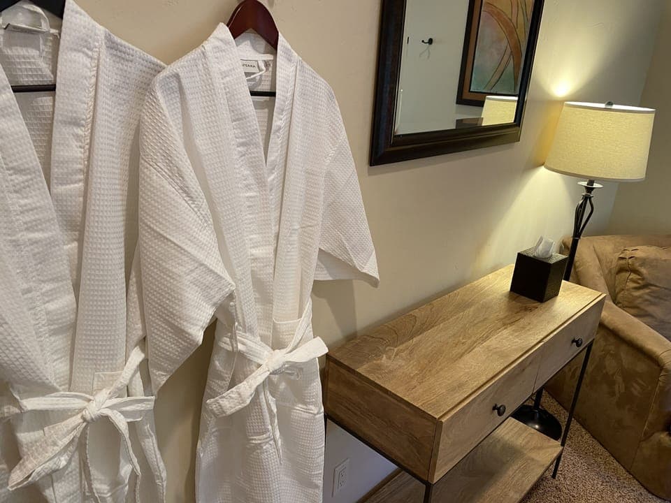 2 bathrooms per bedroom. Photo of second bedroom dresser and sitting area