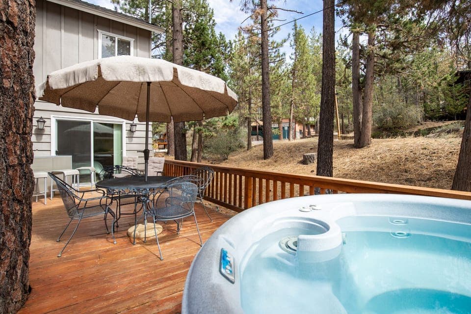 Private outdoor hot tub, surrounded by tall pines, perfect for relaxing under the trees after a day of adventure—enjoy peaceful forest views, fresh air, and a truly rejuvenating stay.