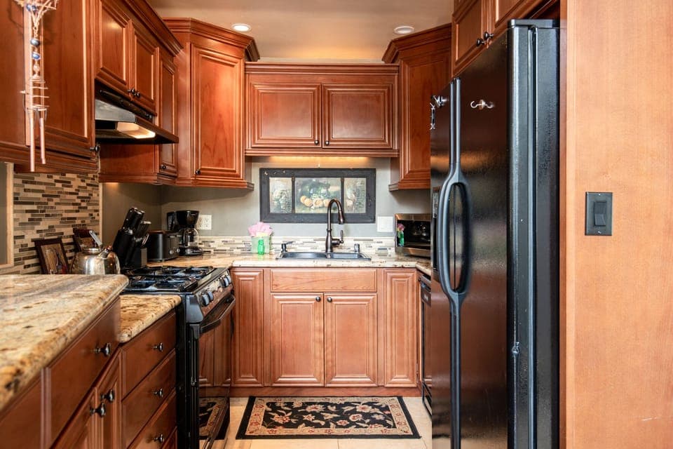 Fully equipped cabin kitchen with ample cabinetry, stove, fridge, microwave, and coffee maker—perfect for cooking meals, morning coffee, and feeling right at home on your stay.