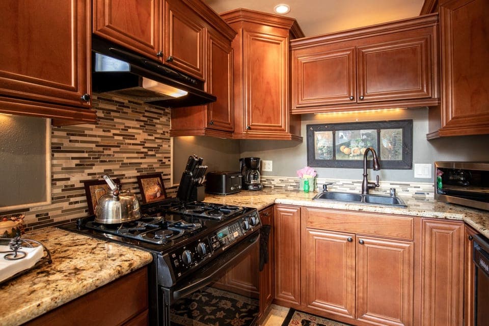 Fully equipped cabin kitchen with ample cabinetry, stove, fridge, microwave, and coffee maker—perfect for cooking meals, morning coffee, and feeling right at home on your stay.