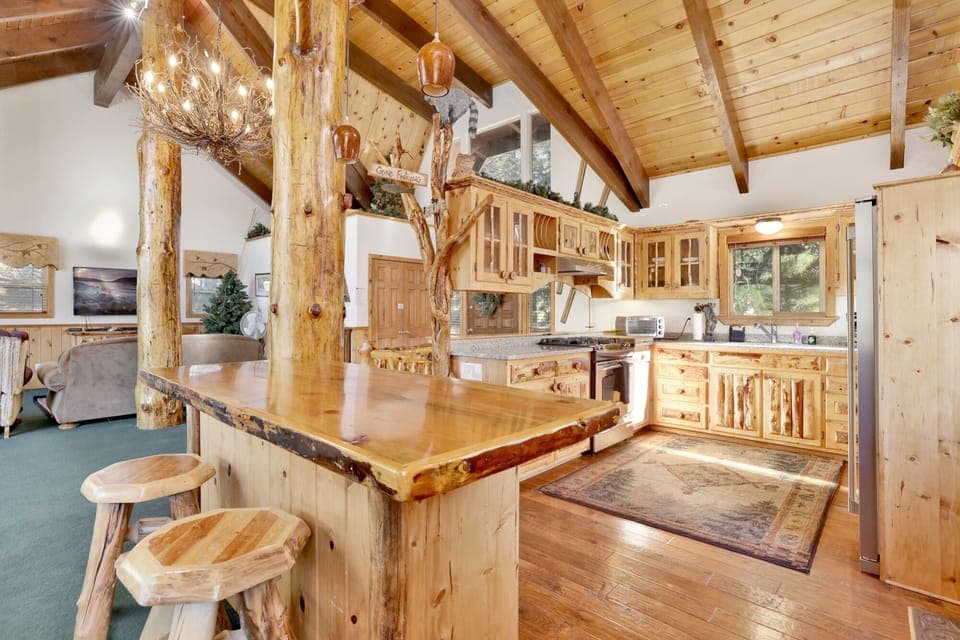 Fully equipped cabin kitchen with ample cabinetry, stove, fridge, microwave, and coffee maker—perfect for cooking meals, morning coffee, and feeling right at home on your stay.