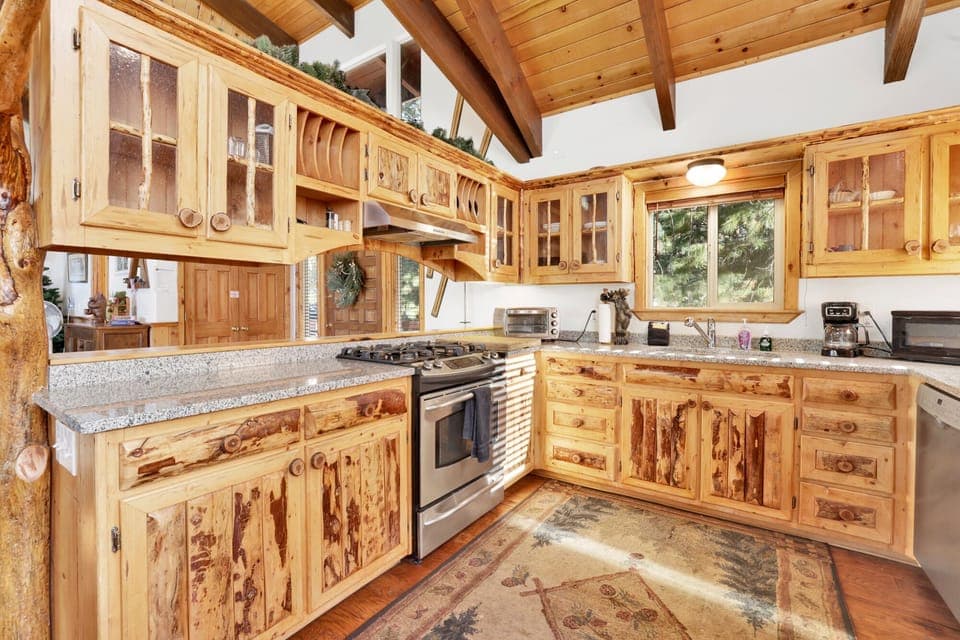 Fully equipped cabin kitchen with ample cabinetry, stove, fridge, microwave, and coffee maker—perfect for cooking meals, morning coffee, and feeling right at home on your stay.
