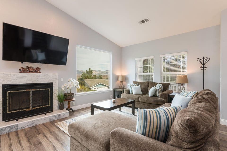 Living room w/ wood burning fireplace