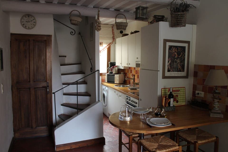 Dining area and kitchenenette, entrance door and stairs up to second level