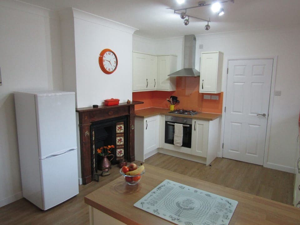Kitchen has feature fireplace.