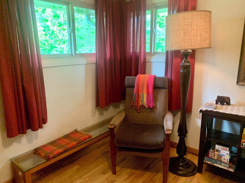 Windows in second bedroom are high for privacy and look out on garden greenery.