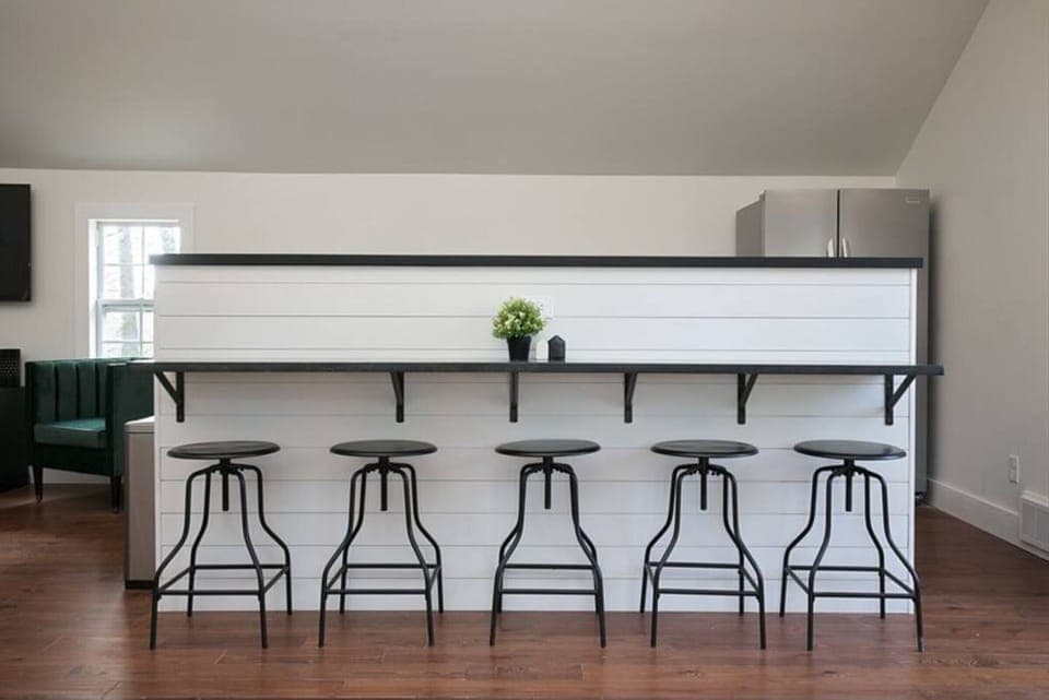 Sleek bar seating for five with modern stools, perfect for dining or entertaining.