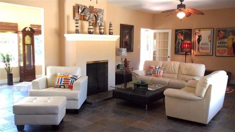 Gather and relax in the oversized living room and adjacent sunroom