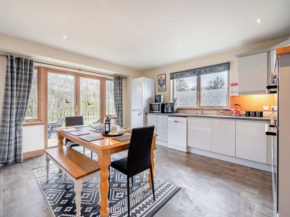Large kitchen/diner with doors to the garden | Croftside House - Allt Mor Cottages, Aviemore