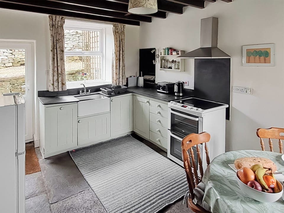 Kitchen and dining area with wood beamed ceiling | Lilac Cottage, Sedbusk, near Hawes