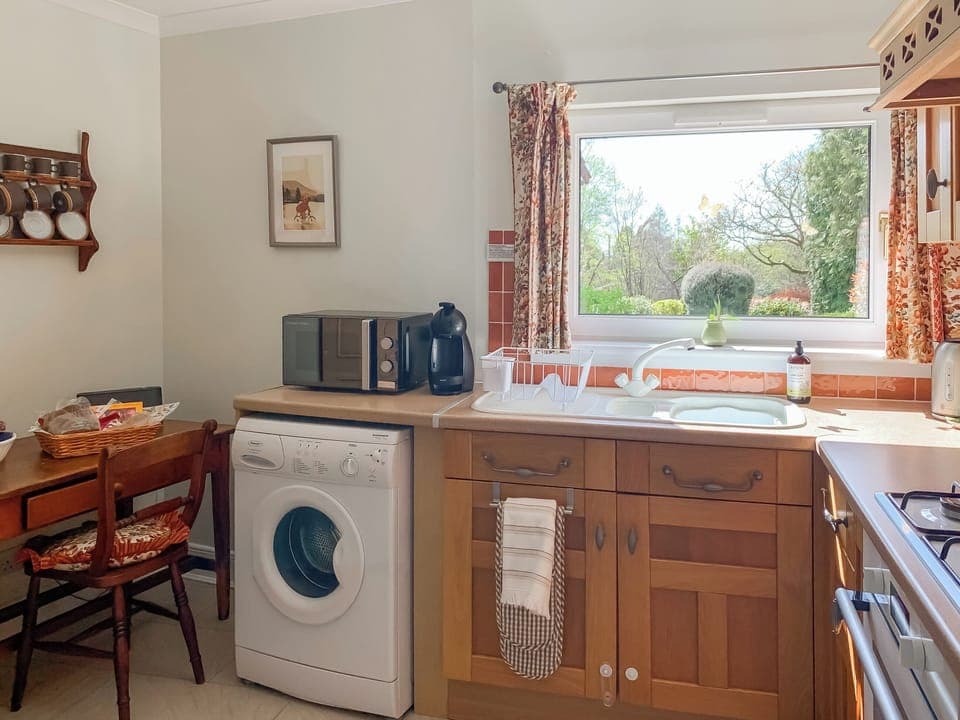 Kitchen overlooking the garden | Capelrig Cottage, Balfron, near Drymen Loch Lomond & The Trossachs