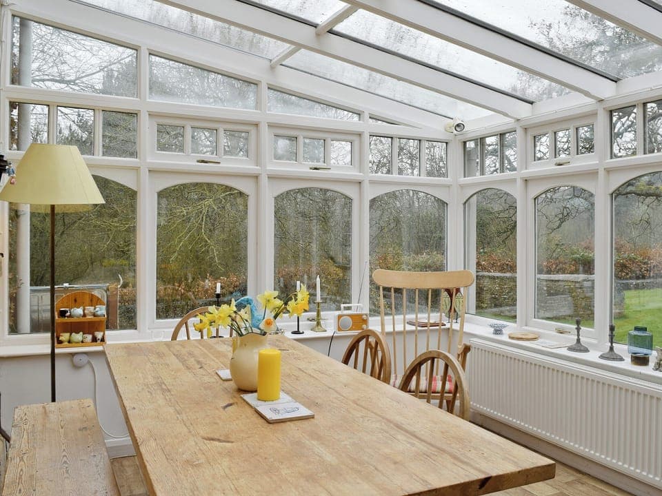Large dining table in the conservatory | Jubilee Cottage, Church Enstone, near Chipping Norton