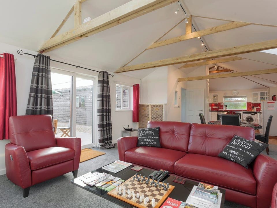 Comfortable lounge area with wood burner and Freeview TV | Swallows&rsquo; Nest, Wool, near Wareham