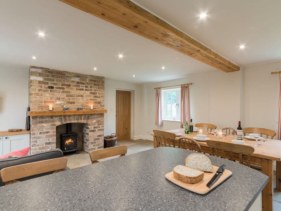 Open plan living space with exposed brickwork and a well-equipped kitchen and dining area | White Lodge Cottage, Carlton Miniott, near Thirsk