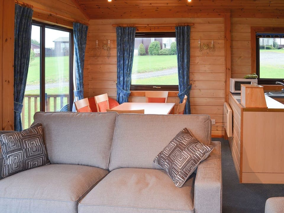 Dining area situated in the corner to take advantage of the wonderful views | Lodge 59, Hartland Forest, near Bideford